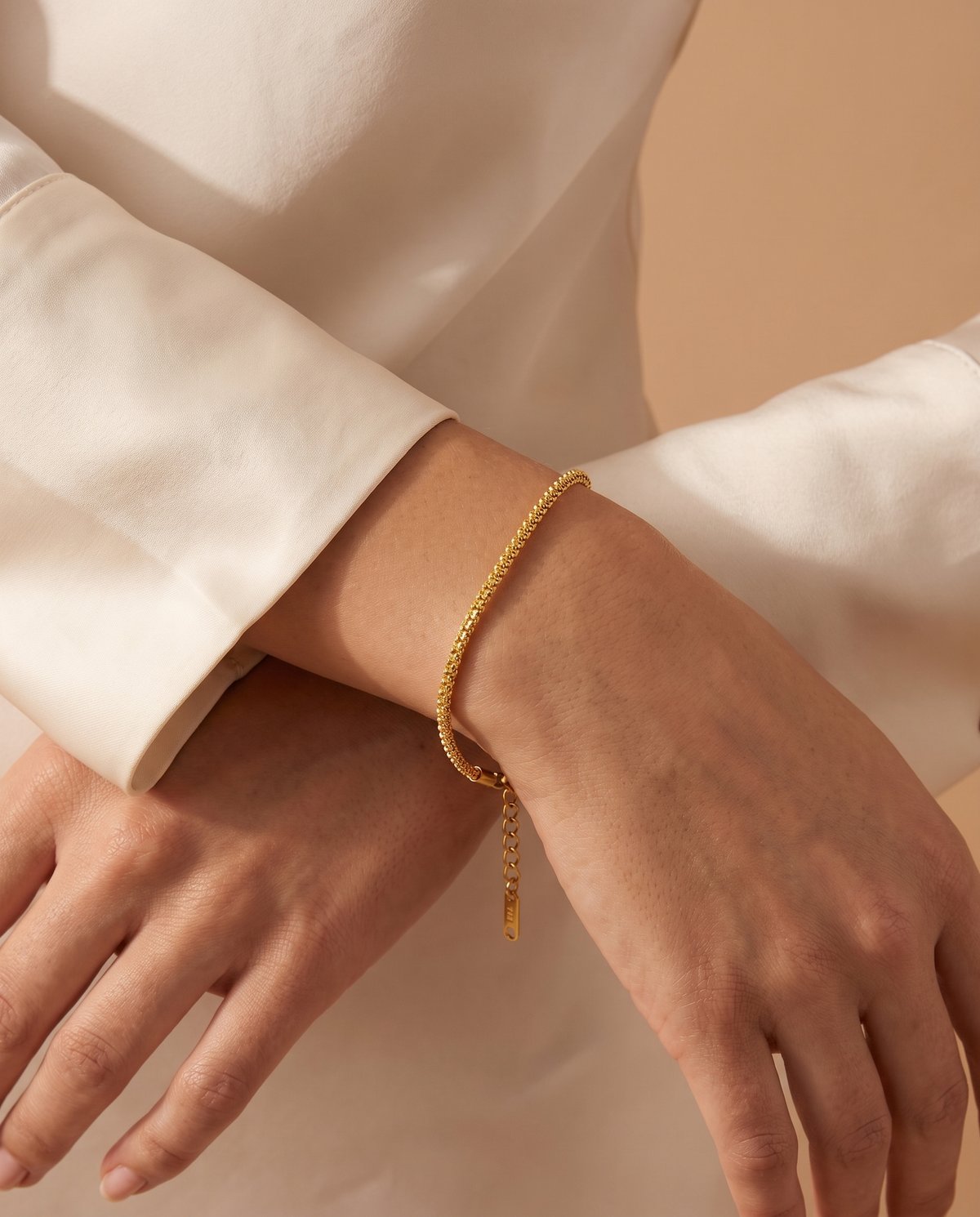 Midnight Charm Bracelet, gold-tone, worn on the wrist | Midnight Charm armband, goudkleurig, gedragen om de pols
