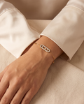 Pure Essence Bracelet, gold-tone, worn on the wrist | Pure Essence armband, goudkleurig, gedragen om de pols