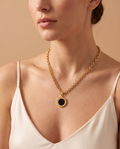 Mystic Moon Necklace, gold-tone cable chain with black Roman numeral pendant worn on model | Mystic Moon ketting, goudkleurige jasseronketting met zwarte hanger met Romeinse cijfers gedragen door model