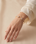 Sunset Glow open bangle worn on the wrist: pear-cut and emerald-cut stone ends | Sunset Glow open bangle om de pols: uiteinden met druppel- en rechthoekige steen