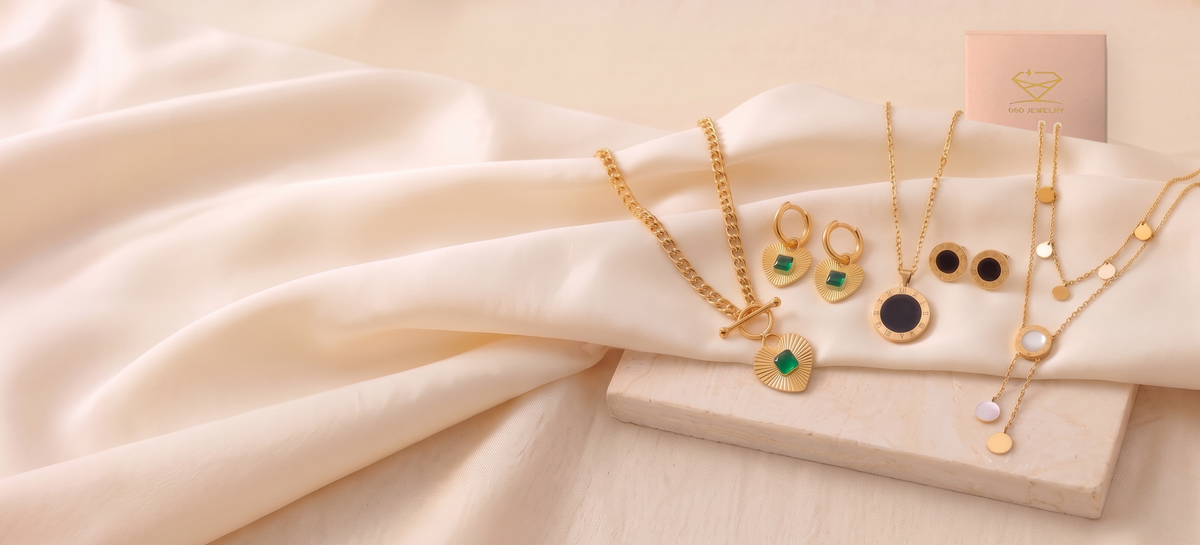 OSO Jewelry gold-tone necklaces and earrings on ivory silk with the pink OSO Jewelry gift box